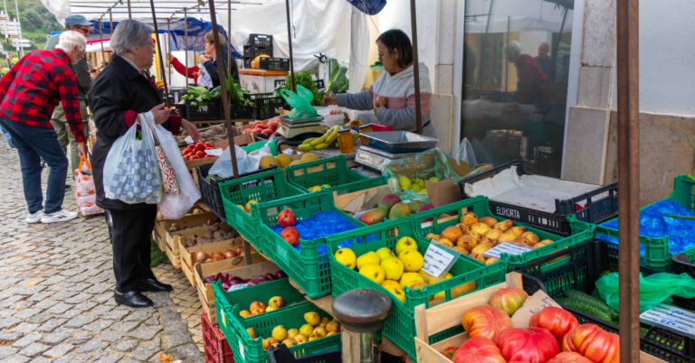 Weekly market people buying vegetables from vendor